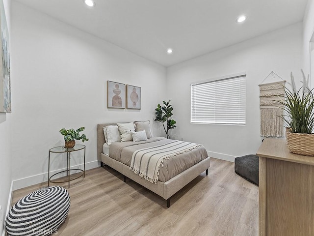 bedroom with baseboards, recessed lighting, and light wood-style floors