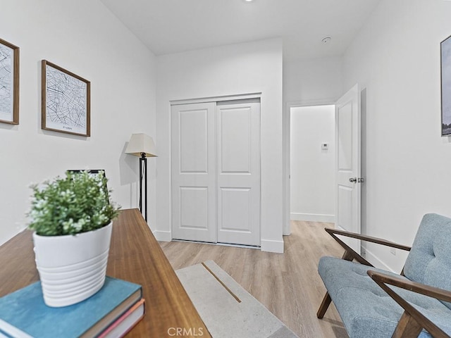 sitting room with light wood-style flooring and baseboards