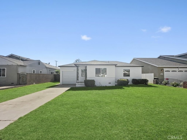 view of front facade featuring a garage, a front yard, fence, and stucco siding