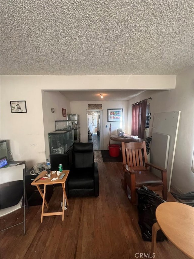 living room featuring a textured ceiling and wood finished floors