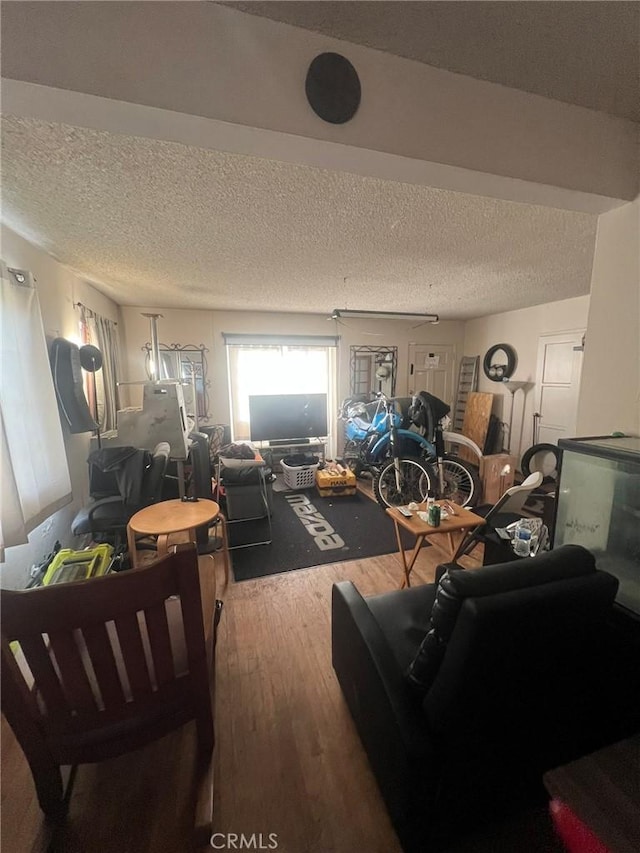 living room with a textured ceiling and wood finished floors