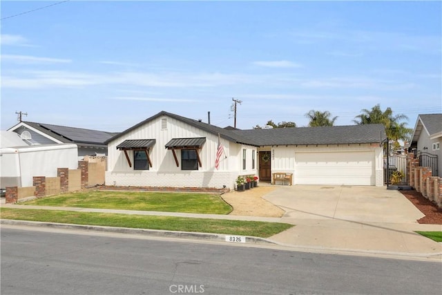 view of front of home featuring driveway, an attached garage, fence, and brick siding