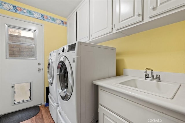 14218 Yellowstone Ln, Canyon Country, CA 91387 - laundry room with independent washer and dryer, cabinet space, and wood finished floors