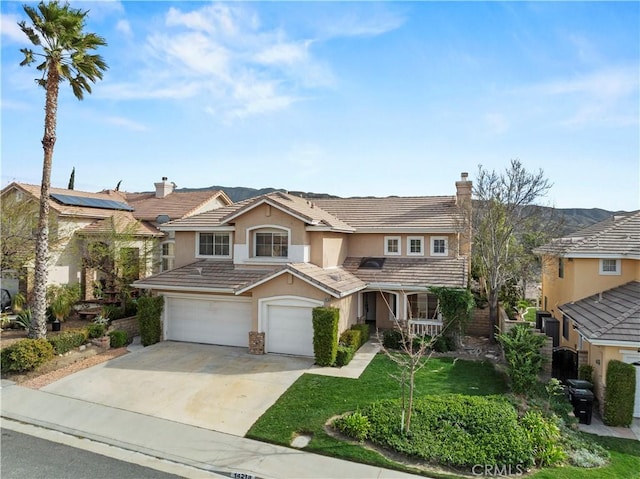 view of front of home with a garage, a tile roof, driveway, stucco siding, and a chimney