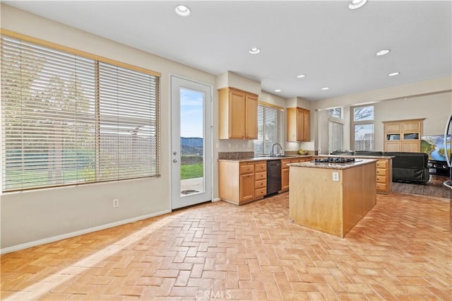 14218 Yellowstone Ln, Canyon Country, CA 91387 - kitchen with black dishwasher, a center island, brick floors, baseboards, and a sink
