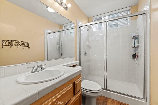 14218 Yellowstone Ln, Canyon Country, CA 91387 - full bath featuring a stall shower, toilet, vanity, and wood finished floors