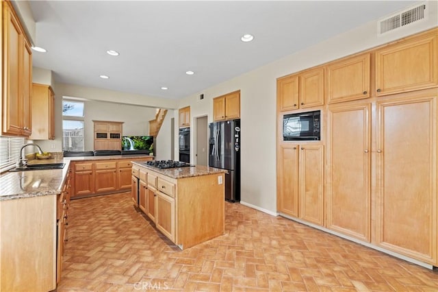 14218 Yellowstone Ln, Canyon Country, CA 91387 - kitchen featuring black appliances, a sink, light brown cabinets, a kitchen island, and light stone counters