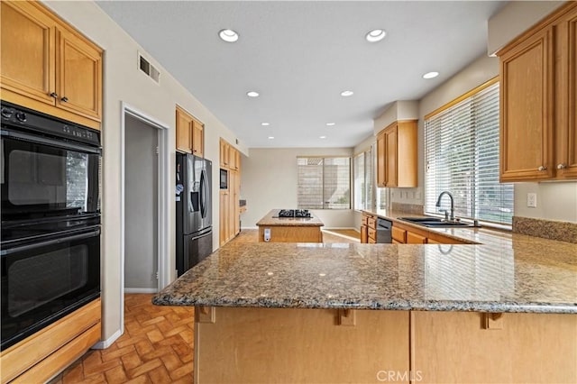14218 Yellowstone Ln, Canyon Country, CA 91387 - kitchen featuring a sink, black appliances, brick flooring, a peninsula, and a breakfast bar