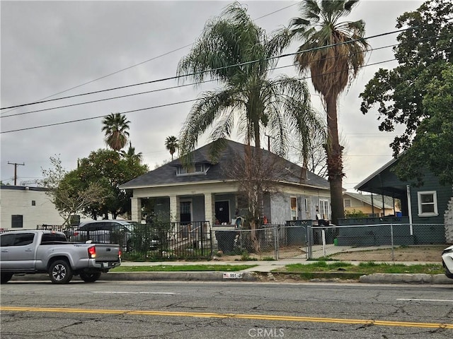 bungalow-style house with a fenced front yard and a gate