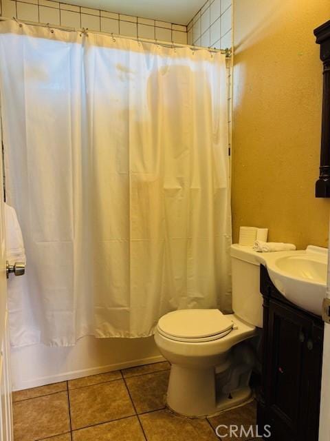 bathroom with shower / tub combo with curtain, vanity, toilet, and tile patterned floors