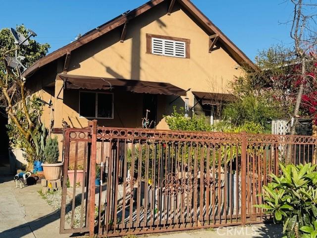 view of front of house with fence and stucco siding