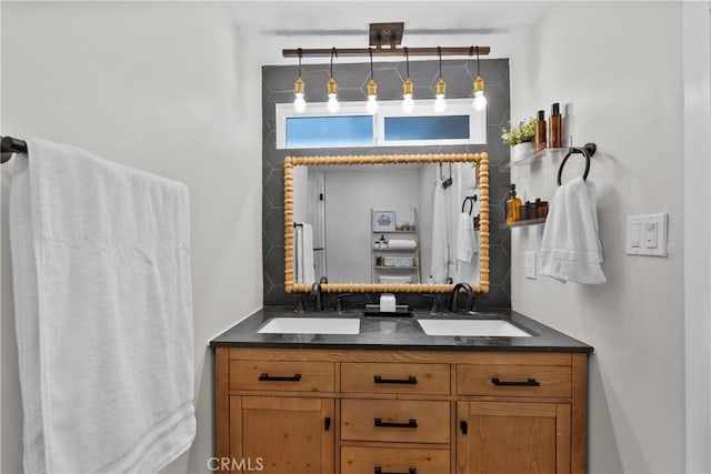 full bathroom with a sink and double vanity