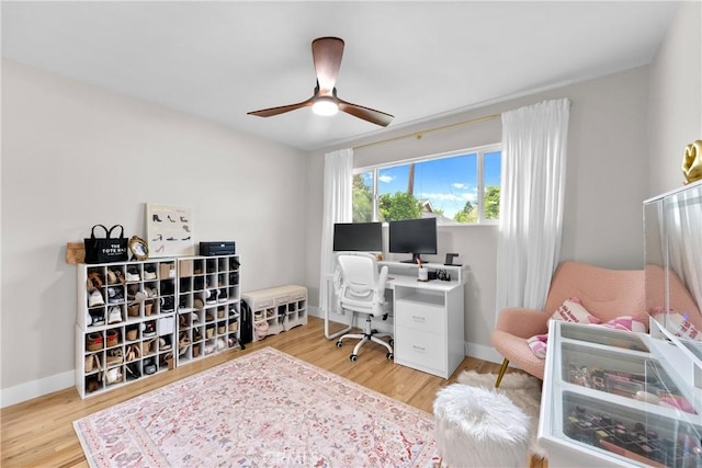 home office with baseboards, a ceiling fan, and wood finished floors