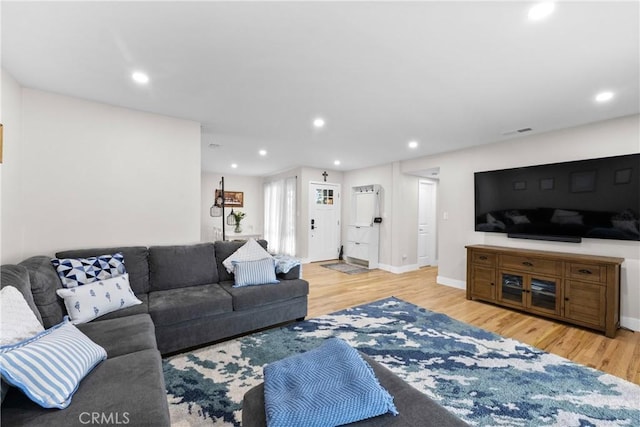 living area with baseboards, recessed lighting, wood finished floors, and visible vents