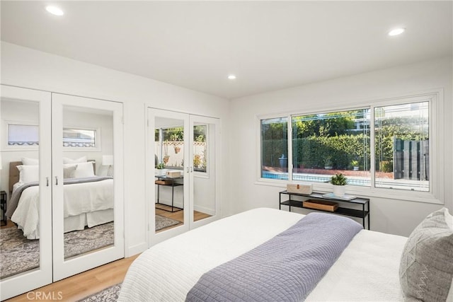 6239 E 6th St, Long Beach, CA 90803 - bedroom featuring french doors, recessed lighting, light wood-type flooring, and multiple closets