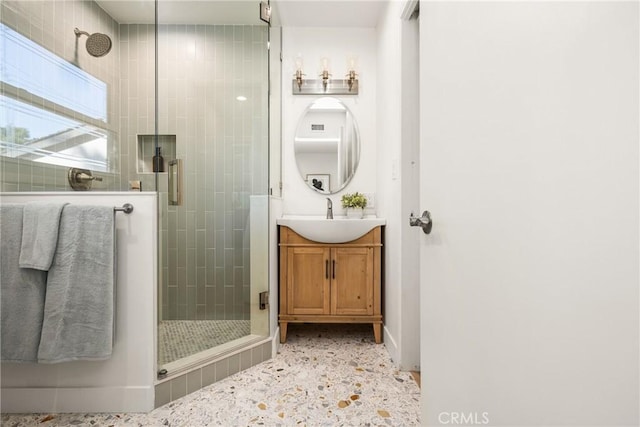 bathroom featuring a stall shower and vanity