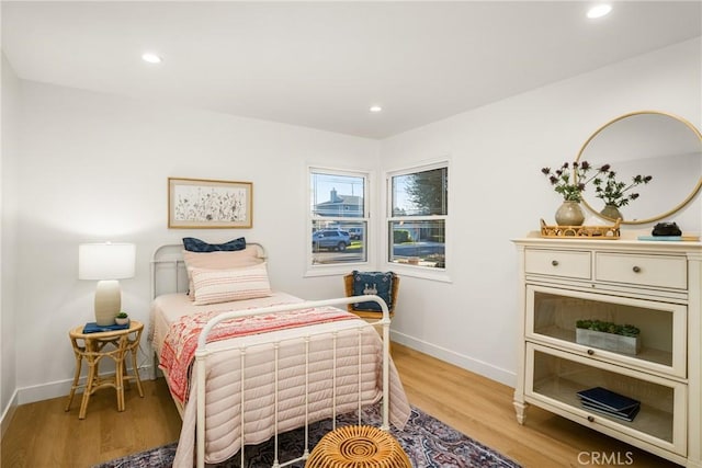 bedroom featuring recessed lighting, light wood-type flooring, and baseboards