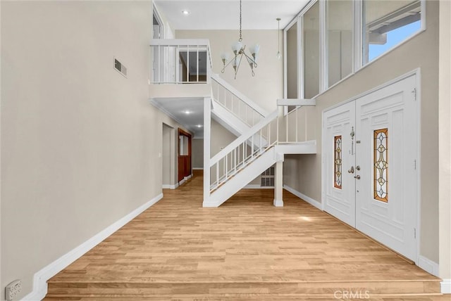 22517 Lazy Meadow Dr, Diamond Bar, CA 91765 - entrance foyer with a chandelier, a towering ceiling, stairway, wood finished floors, and baseboards