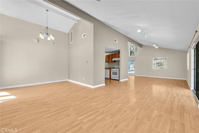 22517 Lazy Meadow Dr, Diamond Bar, CA 91765 - unfurnished living room featuring high vaulted ceiling, light wood-style flooring, baseboards, rail lighting, and a chandelier