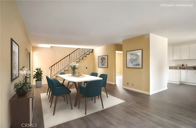 dining area with dark wood-style floors, baseboards, and stairway