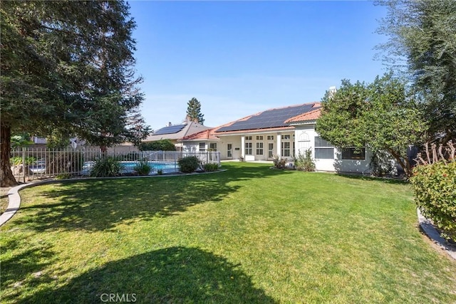 view of yard with a fenced in pool and fence