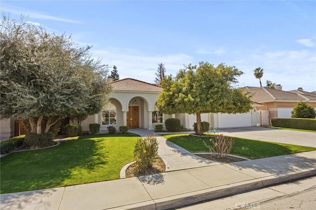 view of front facade featuring driveway, a tiled roof, stucco siding, a front lawn, and a chimney