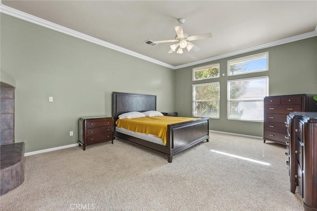 carpeted bedroom featuring baseboards, a ceiling fan, visible vents, and crown molding