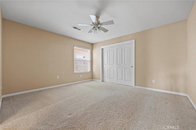 unfurnished bedroom with baseboards, visible vents, ceiling fan, carpet, and a closet