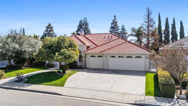 mediterranean / spanish house featuring a garage, concrete driveway, a tiled roof, a front yard, and stucco siding