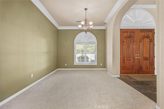 foyer entrance with ornamental molding, carpet flooring, visible vents, and a notable chandelier