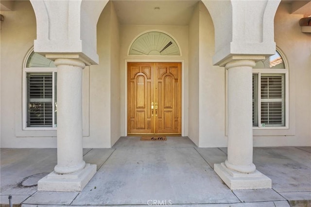 doorway to property with stucco siding