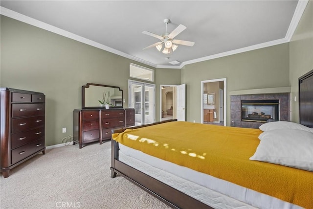 bedroom featuring ornamental molding, baseboards, carpet flooring, and a tiled fireplace