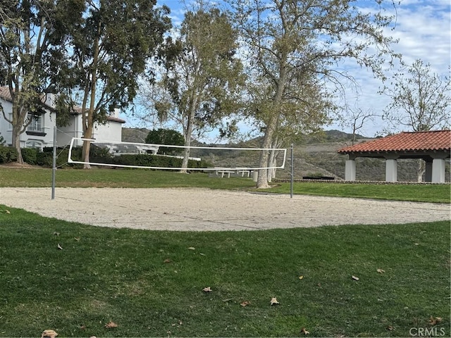 view of home's community with a gazebo, a lawn, and volleyball court