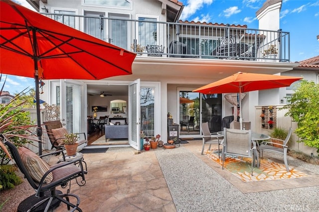 view of patio with outdoor dining area and a balcony