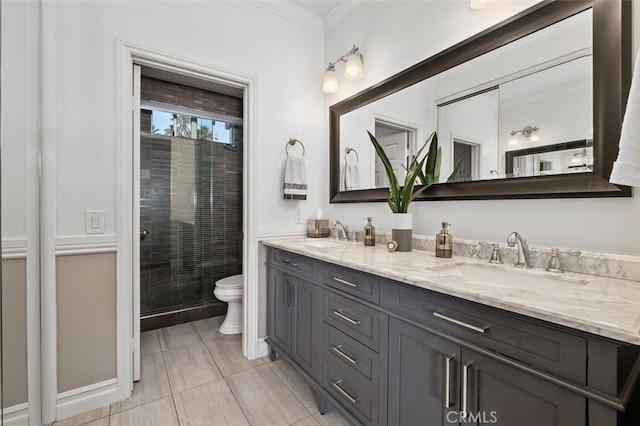 bathroom featuring crown molding, a sink, toilet, and double vanity