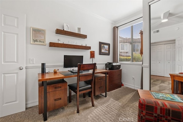 home office with carpet floors, baseboards, visible vents, and ornamental molding