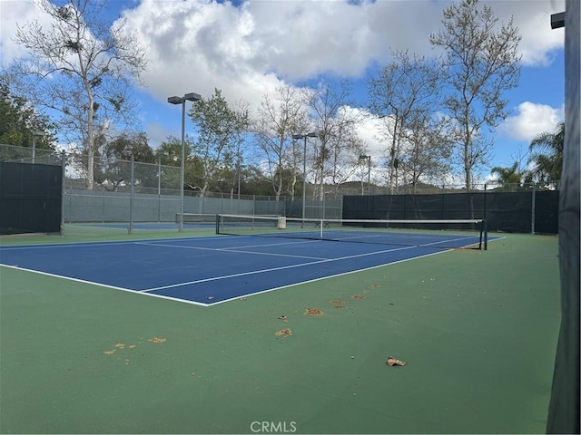 view of sport court with fence