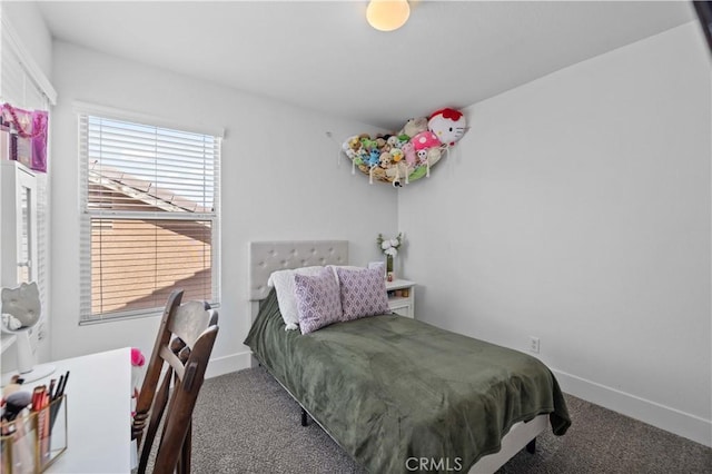 carpeted bedroom featuring baseboards