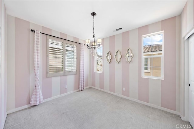 carpeted empty room with plenty of natural light, visible vents, baseboards, and a chandelier