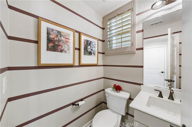 bathroom featuring visible vents, vanity, and toilet