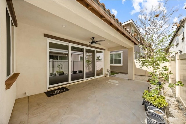 view of patio featuring ceiling fan and fence