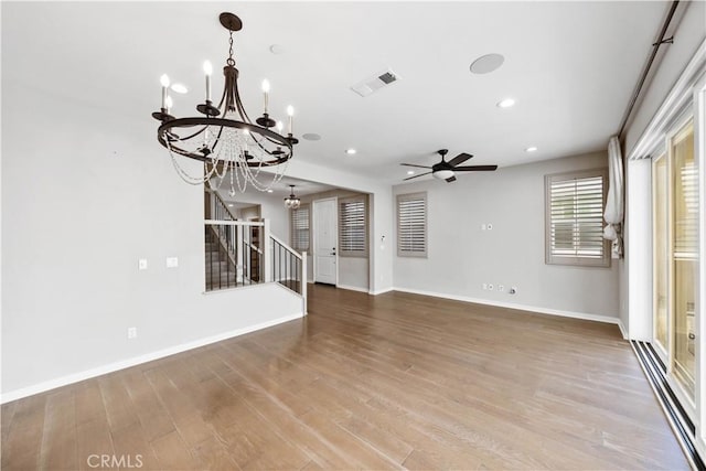 unfurnished living room featuring recessed lighting, wood finished floors, visible vents, baseboards, and stairs