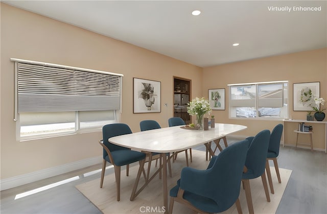 dining area with light wood-style floors, baseboards, and recessed lighting