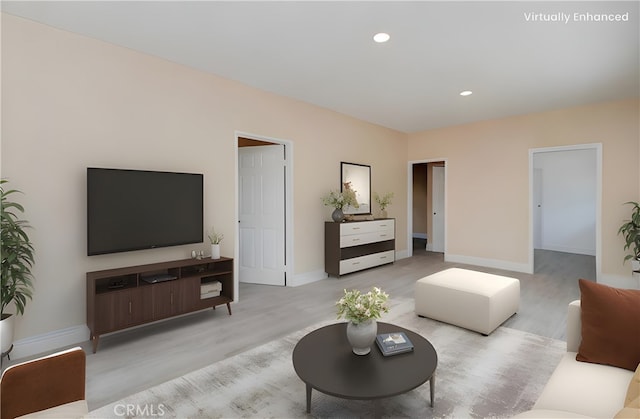 living room featuring baseboards, light wood-style floors, and recessed lighting