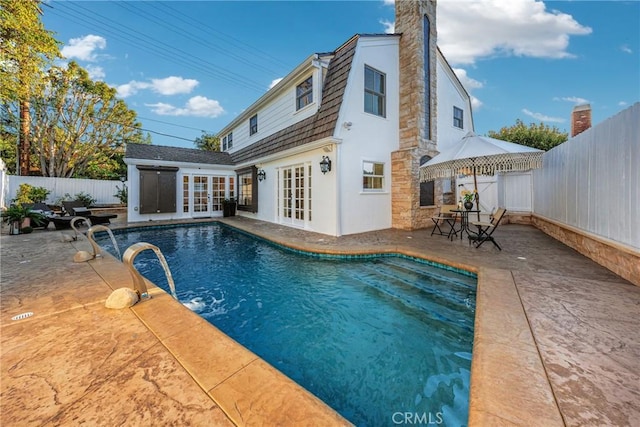 3024 Via Rivera, Palos Verdes Estates, CA 90274 - back of house featuring french doors, a fenced backyard, a patio area, a chimney, and stucco siding
