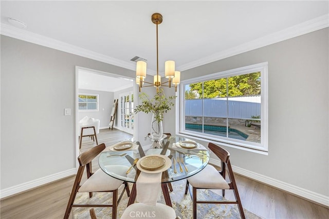 3024 Via Rivera, Palos Verdes Estates, CA 90274 - dining room with a chandelier, light wood-type flooring, plenty of natural light, and crown molding