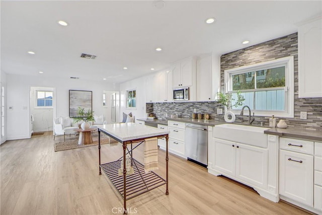 3024 Via Rivera, Palos Verdes Estates, CA 90274 - kitchen with stainless steel appliances, decorative backsplash, recessed lighting, white cabinets, and light wood-style flooring