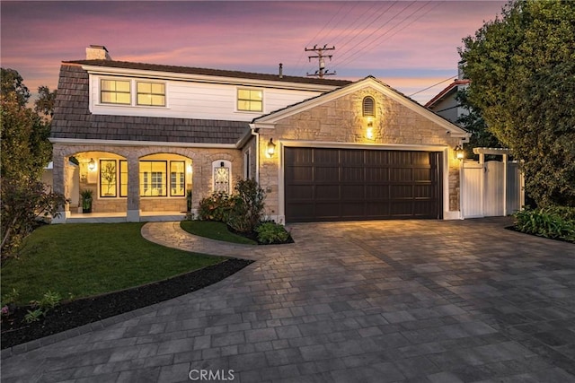 3024 Via Rivera, Palos Verdes Estates, CA 90274 - view of front of property featuring stone siding, a chimney, decorative driveway, and an attached garage