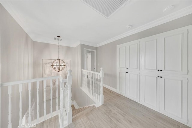 3024 Via Rivera, Palos Verdes Estates, CA 90274 - hall featuring an upstairs landing, light wood-style flooring, a chandelier, and ornamental molding