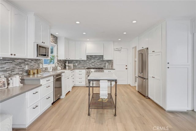 3024 Via Rivera, Palos Verdes Estates, CA 90274 - kitchen with high quality appliances, light wood-style flooring, decorative backsplash, white cabinets, and recessed lighting